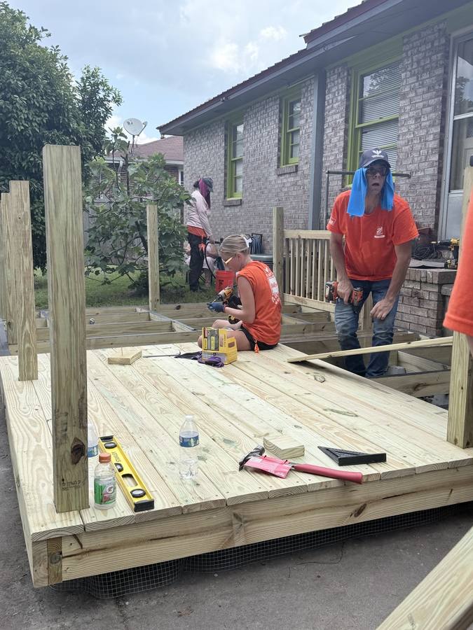 Volunteers building out the deck platform